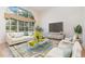 Inviting living room featuring a large window, comfortable seating, and modern entertainment setup at 6121 Oxbow Bend Ln, Port Orange, FL 32128
