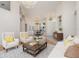 Bright living room has two white armchairs, neutral-colored couch, and a dark brown coffee table at 6121 Oxbow Bend Ln, Port Orange, FL 32128