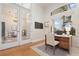 Bright office with a wood desk, a cream chair, and a neutral rug is perfect for remote working at 6121 Oxbow Bend Ln, Port Orange, FL 32128