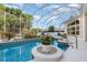 Sparkling pool with a screen enclosure, surrounded by lush landscaping at 6121 Oxbow Bend Ln, Port Orange, FL 32128
