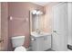 Cozy bathroom with a white vanity, toilet, and soft pink walls for a calming atmosphere at 6360 Ranelagh Dr # 104, Orlando, FL 32835