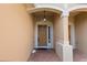 Inviting front entrance with brick pathway, decorative light fixture, and classic brown door under an arched entryway at 6360 Ranelagh Dr # 104, Orlando, FL 32835