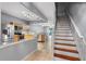 Open-concept kitchen with stainless steel appliances, light wood cabinetry, and a view leading to the living area and stairs at 6360 Ranelagh Dr # 104, Orlando, FL 32835
