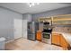 Functional kitchen featuring stainless steel appliances, light wood cabinetry, and tiled flooring for easy maintenance at 6360 Ranelagh Dr # 104, Orlando, FL 32835