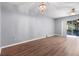 Bright living room featuring wood floors, modern chandelier, and sliding glass doors to screened patio at 6360 Ranelagh Dr # 104, Orlando, FL 32835