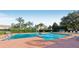Community pool surrounded by lush landscaping and comfortable lounge chairs for relaxation at 6360 Ranelagh Dr # 104, Orlando, FL 32835