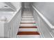 Stairway with white rails and wood trim on each step leading to the next level of the home at 6360 Ranelagh Dr # 104, Orlando, FL 32835