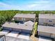 Aerial view showcasing the community's townhomes, garages, and lush green surroundings at 7508 Bentonshire Ave, Windermere, FL 34786