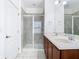 Bathroom featuring dual sinks, a glass shower, and tile flooring at 7508 Bentonshire Ave, Windermere, FL 34786