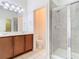 Bathroom with double vanity, tiled floor, glass enclosed shower, and great lighting at 7508 Bentonshire Ave, Windermere, FL 34786