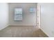 Bright bedroom featuring neutral carpeting and two bright windows with white blinds at 7508 Bentonshire Ave, Windermere, FL 34786