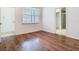 Cozy bedroom with wood floors, natural light, and bathroom access at 7508 Bentonshire Ave, Windermere, FL 34786