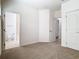 Spacious bedroom featuring neutral carpeting, white walls, and an ensuite bathroom at 7508 Bentonshire Ave, Windermere, FL 34786