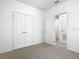 Bedroom featuring carpet floors and double doors to closet at 7508 Bentonshire Ave, Windermere, FL 34786