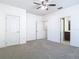 Bedroom with neutral carpet, ceiling fan, and ensuite bathroom at 7508 Bentonshire Ave, Windermere, FL 34786