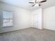 Bright bedroom offers neutral carpet and a ceiling fan at 7508 Bentonshire Ave, Windermere, FL 34786