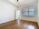 Bedroom with wood floors, neutral paint, ceiling fan, and a view to the outside at 7508 Bentonshire Ave, Windermere, FL 34786