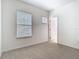 Cozy bedroom featuring neutral carpeting and two bright windows with white blinds at 7508 Bentonshire Ave, Windermere, FL 34786