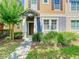 Inviting townhouse with a covered entryway and nicely maintained front yard landscaping at 7508 Bentonshire Ave, Windermere, FL 34786