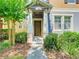 Stylish townhouse featuring a covered entryway and well-kept landscaping at 7508 Bentonshire Ave, Windermere, FL 34786
