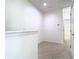 Upstairs hallway with neutral carpet, white trim, and natural lighting at 7508 Bentonshire Ave, Windermere, FL 34786