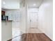 View from hallway into kitchen featuring tile flooring, black appliances, and natural light at 7508 Bentonshire Ave, Windermere, FL 34786