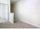 Upstairs hallway with neutral carpet and natural lighting at 7508 Bentonshire Ave, Windermere, FL 34786