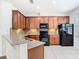 Well-equipped kitchen featuring wood cabinets, granite countertops, and modern appliances at 7508 Bentonshire Ave, Windermere, FL 34786