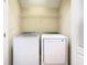 Convenient laundry room features a modern washer and dryer set with overhead shelving at 7508 Bentonshire Ave, Windermere, FL 34786