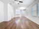 Spacious living room with wood floors, arched entryway, and an open layout at 7508 Bentonshire Ave, Windermere, FL 34786