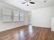 Bright and airy living room with hardwood floors, ceiling fan, and large windows at 7508 Bentonshire Ave, Windermere, FL 34786