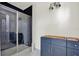 Bathroom featuring a glass shower, dark blue vanity and modern fixtures at 9241 Eagles Perch Pl, Orlando, FL 32825