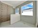 Bathroom featuring a window and gray tile in the shower at 9241 Eagles Perch Pl, Orlando, FL 32825