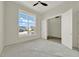 Bedroom featuring a large window and double doors at 9241 Eagles Perch Pl, Orlando, FL 32825
