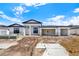 New construction featuring a white exterior, black roof, and open three car garage at 9241 Eagles Perch Pl, Orlando, FL 32825
