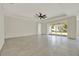 Living room showcasing large sliding glass doors and a tray ceiling at 9241 Eagles Perch Pl, Orlando, FL 32825