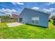 Backyard featuring green grass, a patio, a blue house, and a wooden fence at 3010 Egrets Landing Dr, Lake Mary, FL 32746