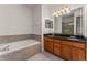 Bathroom featuring a double vanity with a dark countertop and tile flooring at 3010 Egrets Landing Dr, Lake Mary, FL 32746