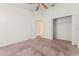 Carpeted bedroom features a ceiling fan, closet, and view to en suite bathroom at 3010 Egrets Landing Dr, Lake Mary, FL 32746