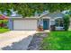 Charming single-story home with a well-manicured lawn, blue exterior, and a two-car garage at 3010 Egrets Landing Dr, Lake Mary, FL 32746