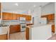 Bright and open kitchen features tiled floors, light wood cabinets, and modern appliances at 3010 Egrets Landing Dr, Lake Mary, FL 32746