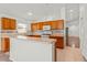 Inviting kitchen with tiled floors, warm wood cabinets, and modern appliances at 3010 Egrets Landing Dr, Lake Mary, FL 32746