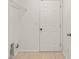 Laundry room with tile floors and white walls, adjacent to storage shelves and a white door at 3010 Egrets Landing Dr, Lake Mary, FL 32746