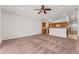 Spacious carpeted living room with view of kitchen and breakfast bar; neutral paint at 3010 Egrets Landing Dr, Lake Mary, FL 32746