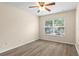 Bright bedroom with wood-look flooring, a window, and a ceiling fan at 1062 Wickerwood St, Ocoee, FL 34761
