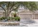 Charming townhome featuring a neutral color scheme, a two-car garage, and lush landscaping in a well-maintained community at 1062 Wickerwood St, Ocoee, FL 34761