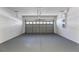 Spacious two-car garage featuring painted walls and a sectional garage door at 1062 Wickerwood St, Ocoee, FL 34761