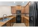 Kitchen with stainless steel appliances, wooden cabinets, and tile backsplash at 1062 Wickerwood St, Ocoee, FL 34761
