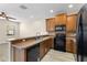 Kitchen with stainless steel appliances, breakfast bar, and wood flooring at 1062 Wickerwood St, Ocoee, FL 34761