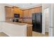 Kitchen with stainless steel appliances, wood cabinets, and pantry at 1062 Wickerwood St, Ocoee, FL 34761